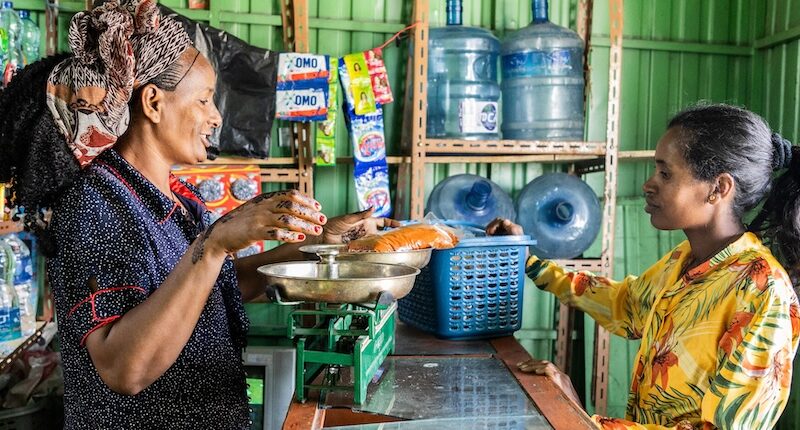 Birhan (right) delivers spices to her neighbor, Tsega Zenebe, in Ethiopia’s Tigray region.