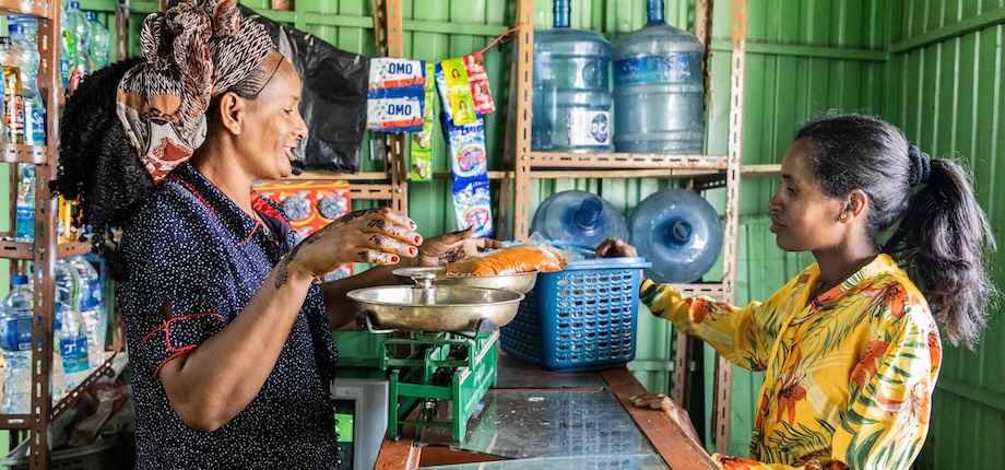 Birhan (right) delivers spices to her neighbor, Tsega Zenebe, in Ethiopia’s Tigray region.