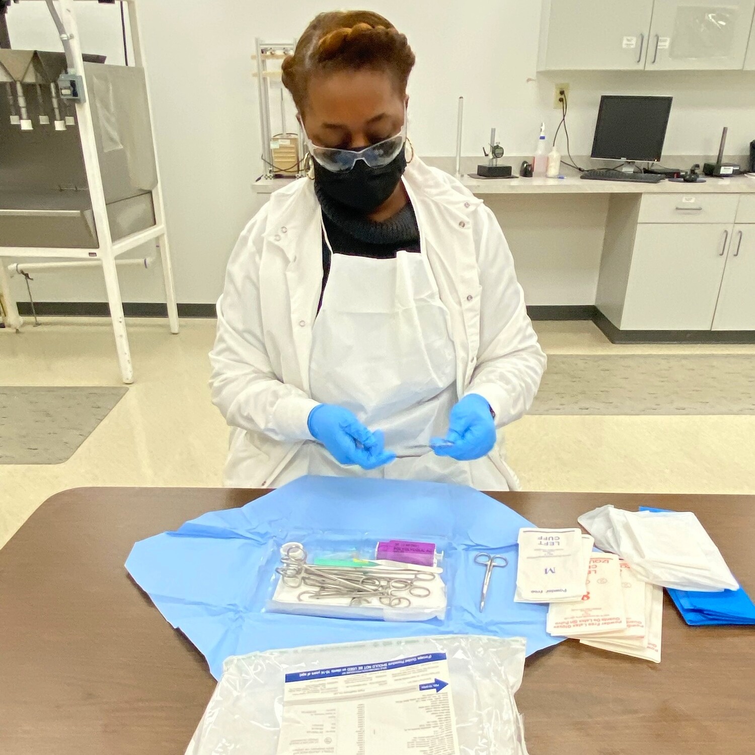 A lab technician inspects a kit.