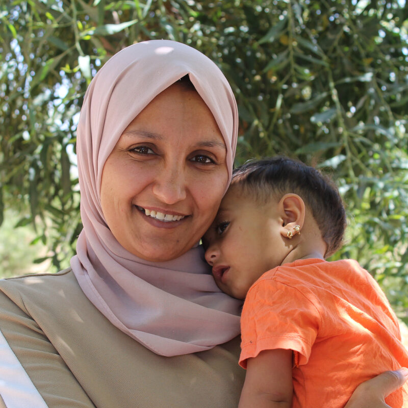 A woman holds her young daughter