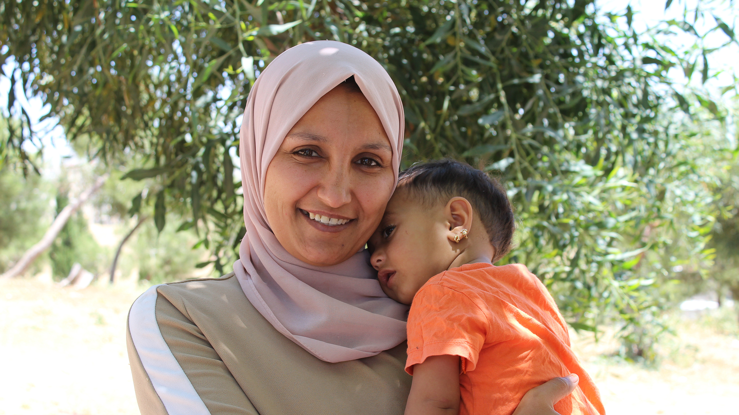 A woman holds her young daughter