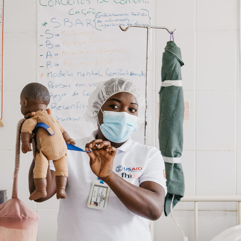 instructor holding plastic doll during birth simulation training