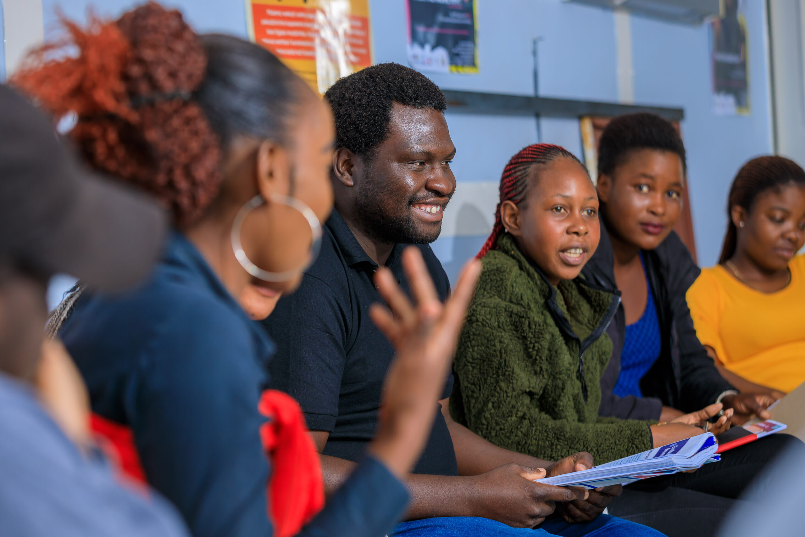 smiling group discussion in circle in Zimbabwe