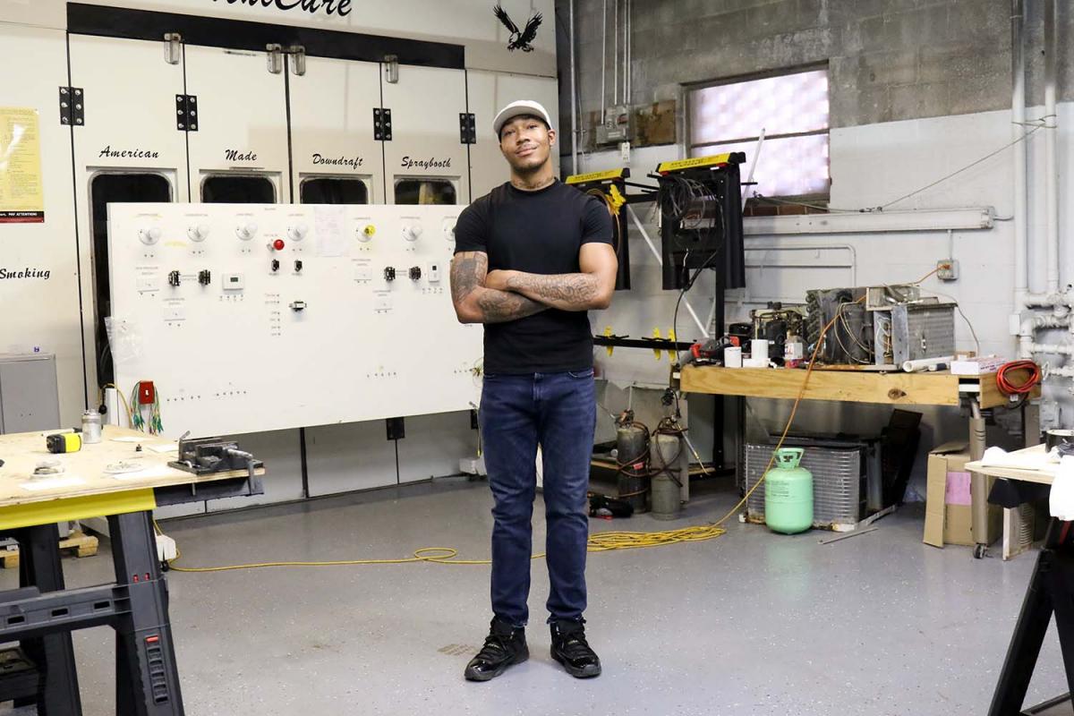 Kani Jones standing in the middle of the HVAC/R workshop