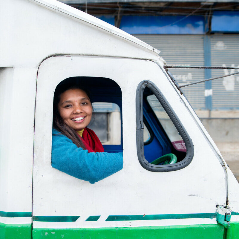 woman smiling driving electric vehicle