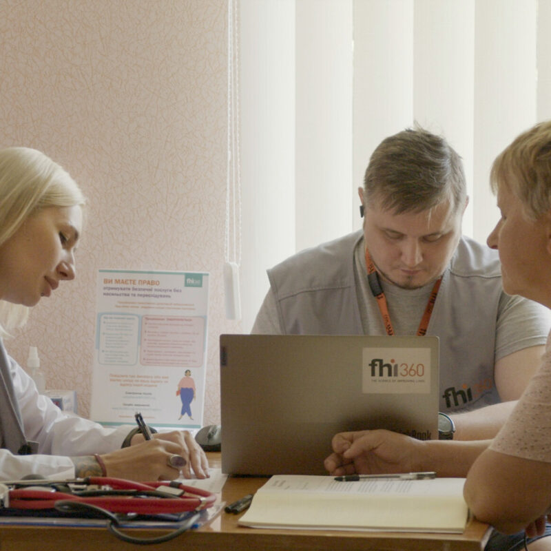 A doctor and nurse care for a patient in a mobile medical clinic