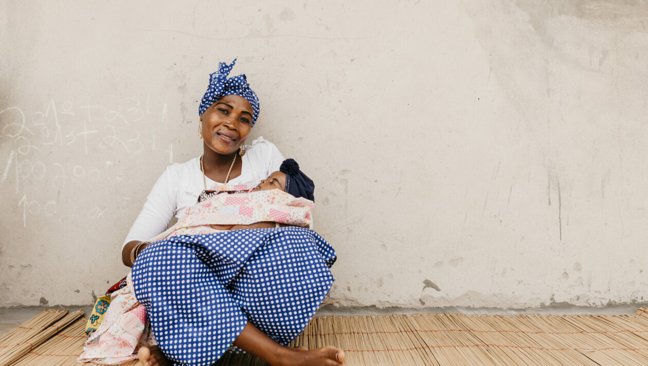 Woman sitting with newborn baby