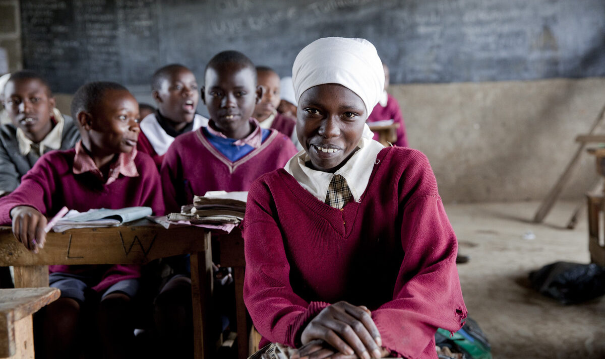 Girls sit at desks in a classroom