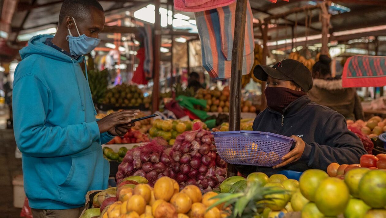 A produce market in Kenya where people are wearing face masks