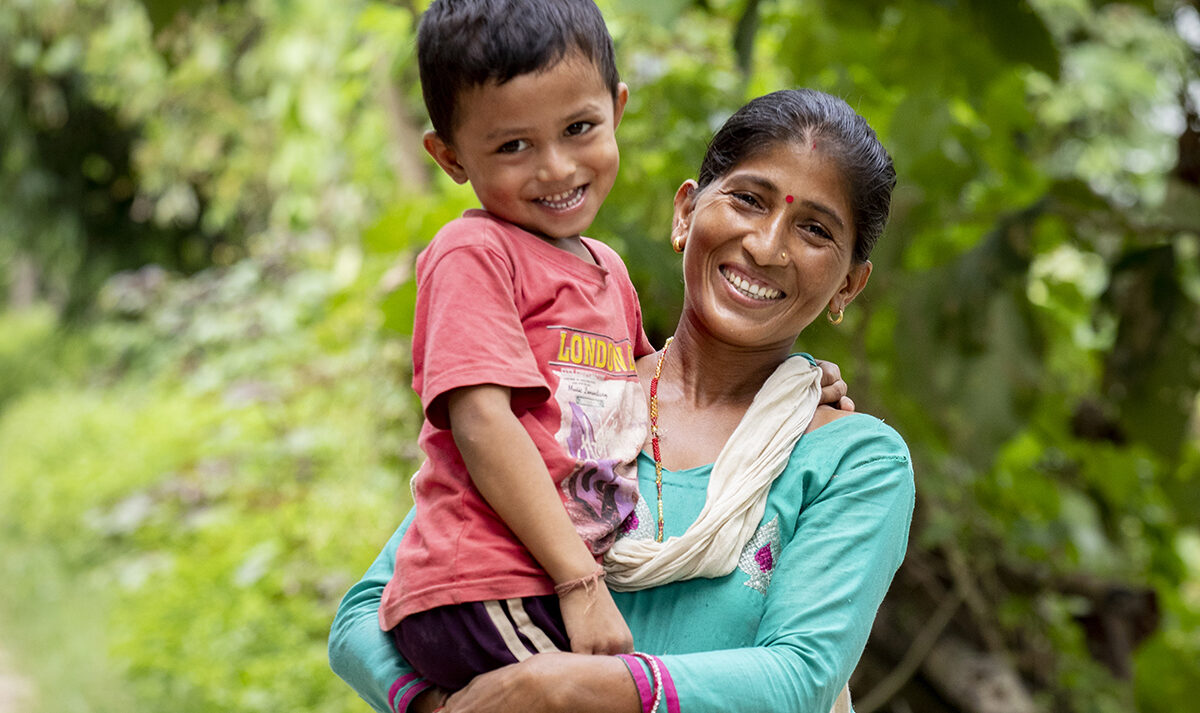 A mother holds her young son in her arms