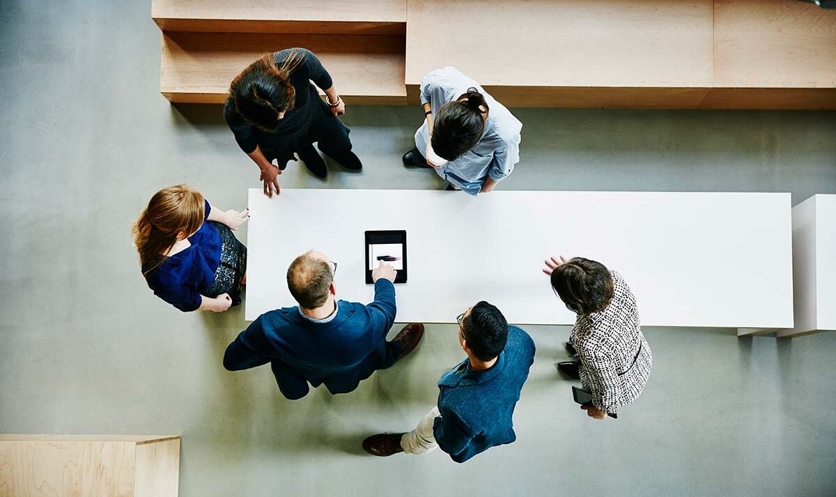 An overhead view of a group of coworkers around a table