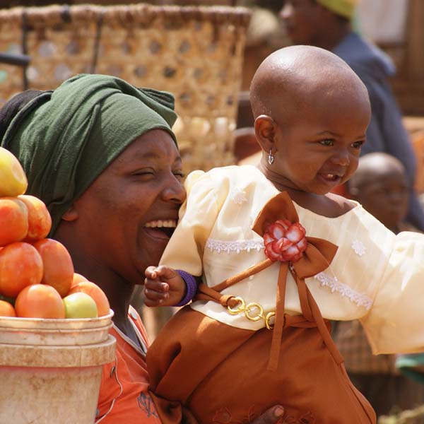 woman smiling with baby on lap