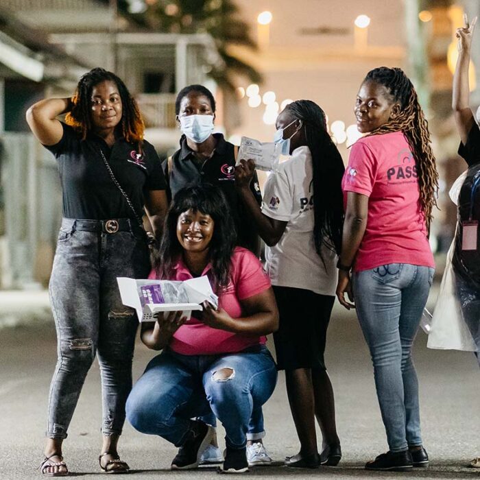 HIV prevention staff pose for a photo on the street