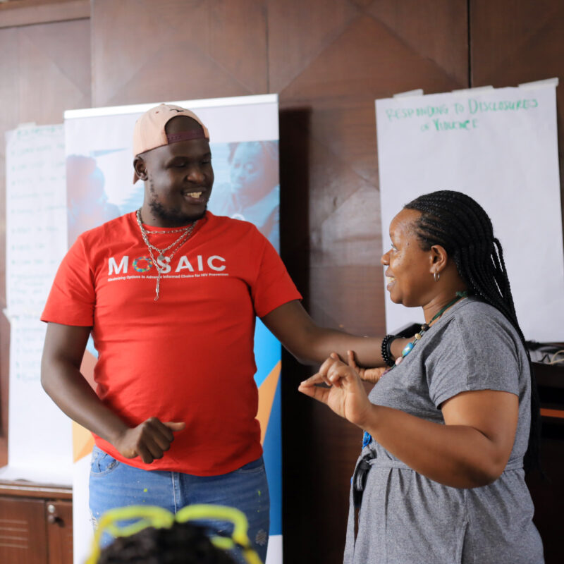 man smiling speaking to woman