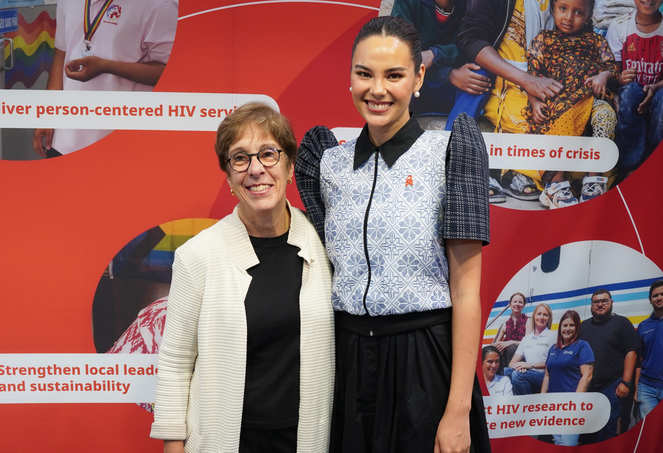 FHI 360 smiling at left posing with Catriona Gray