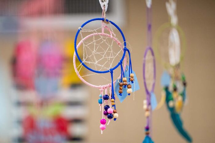 Colorful dreamcatchers hang from the ceiling.