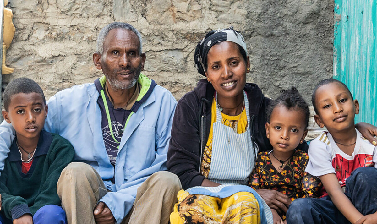 Family of 5 sit with their children outside their home in Ethiopia’s Tigray region.