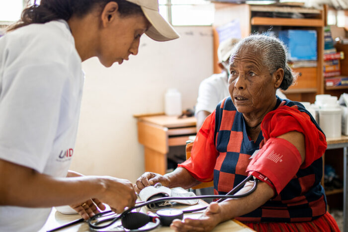 Older woman gets her blood pressure checked.