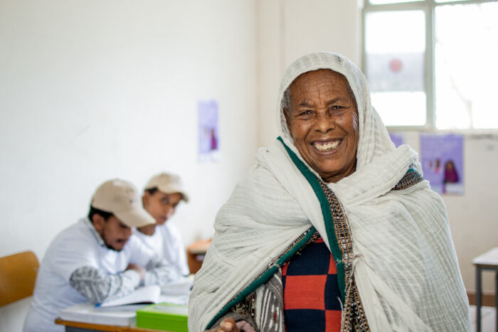 Older Ethiopian women smiles after her health exam.