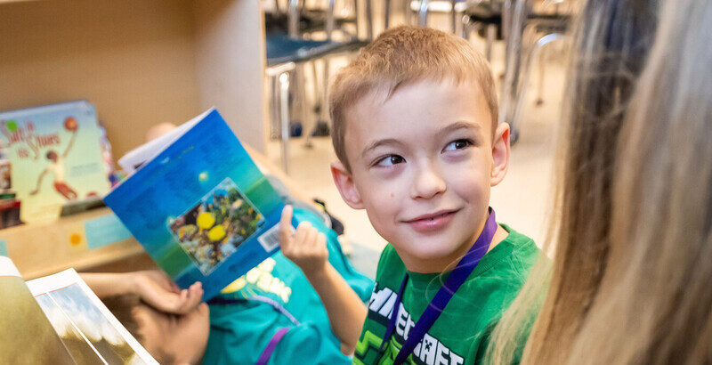 Boy and teacher read book