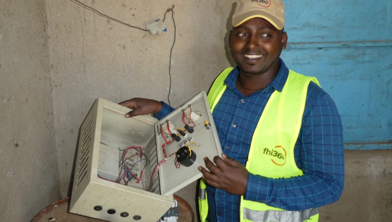 An engineer examines damage in a switchboard