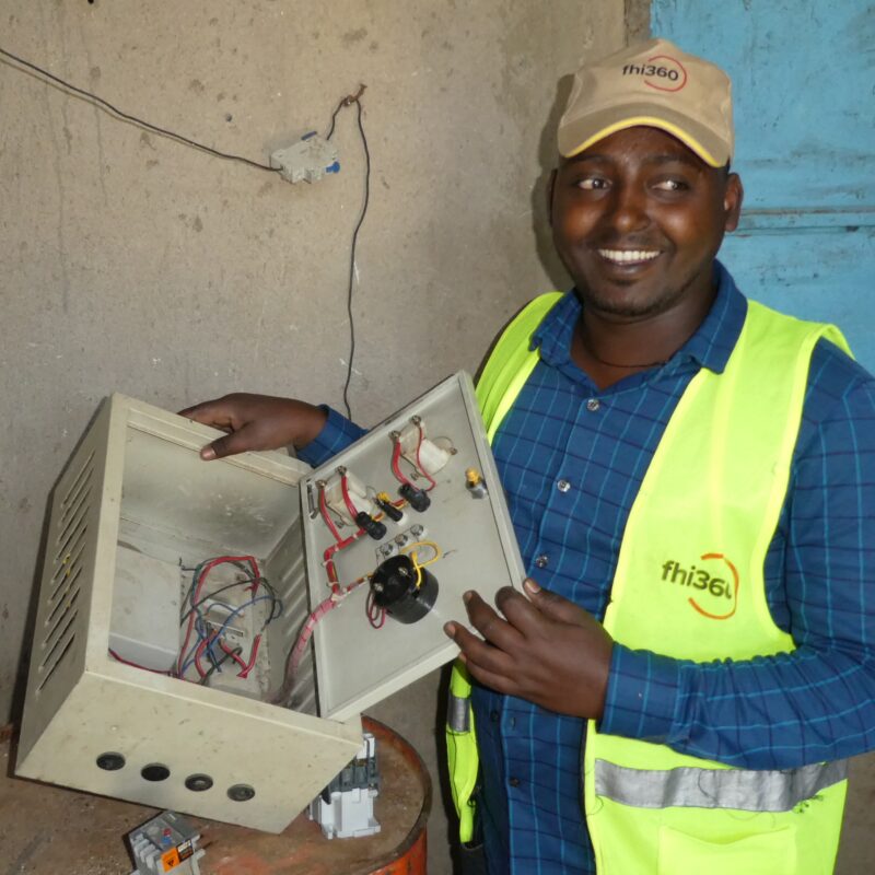 An engineer examines damage in a switchboard