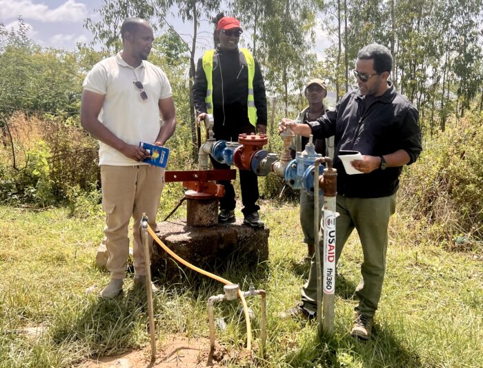 Engineers working on a water pipe system