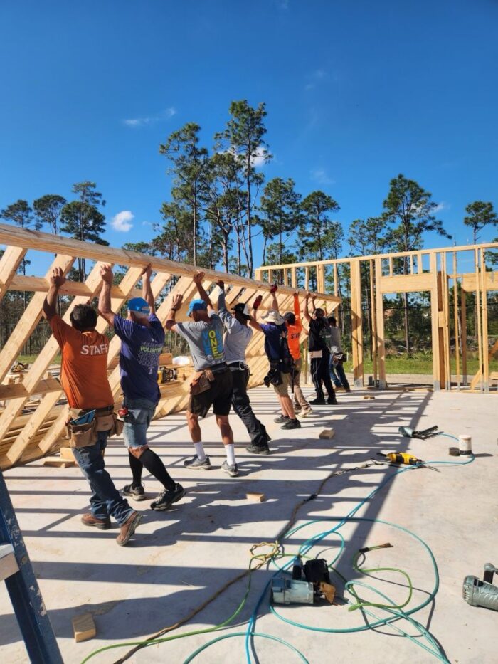 Group lifts building wooden frame