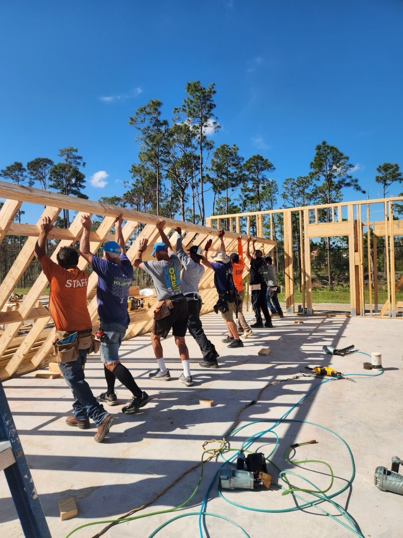 Group lifts building wooden frame
