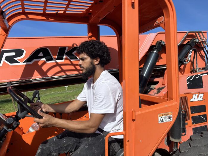 Young man drives a large machine