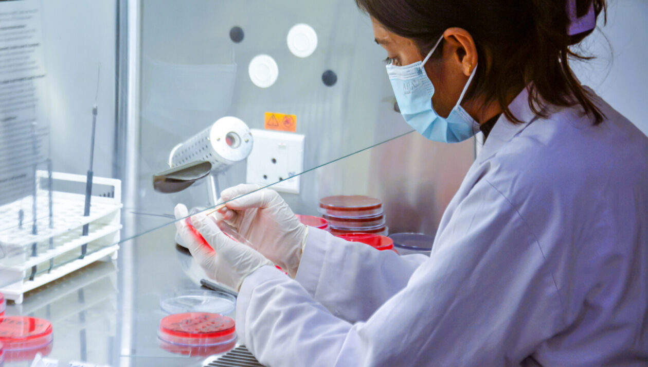 A lab technician works with a sample.