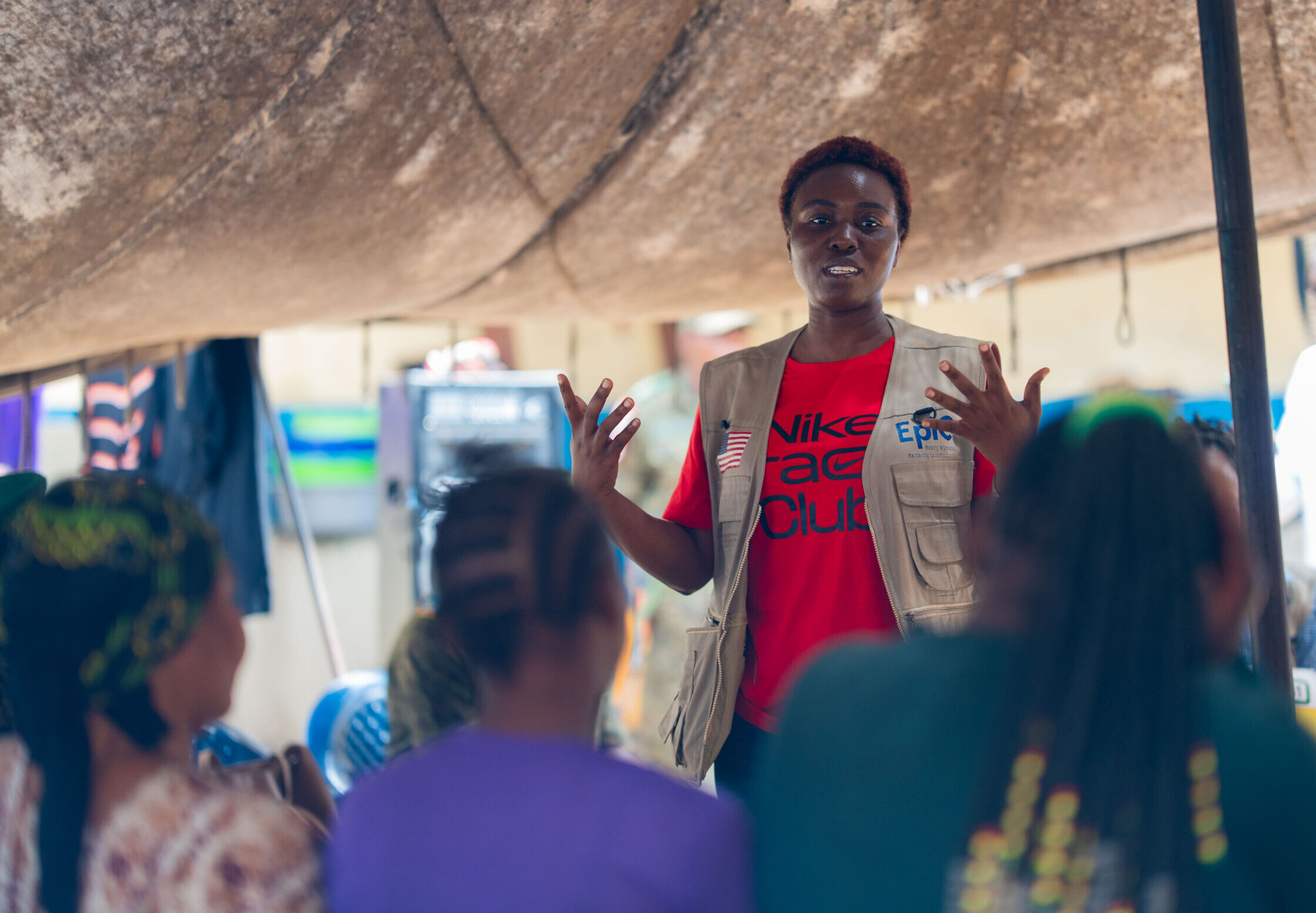 A woman speaks at an ebola training in front of a group of people.