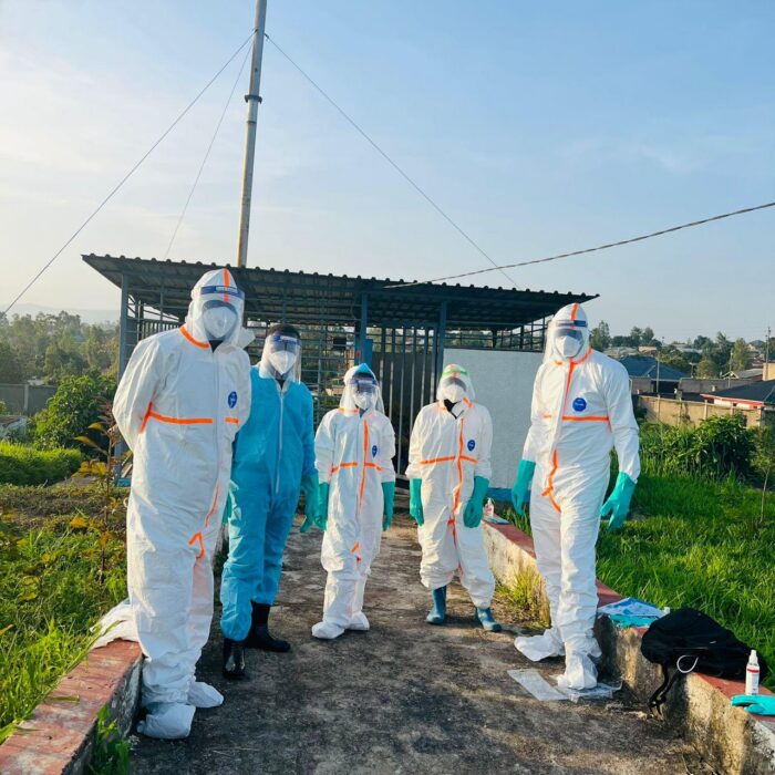 A group of staff members standing outside in personal protective gear.