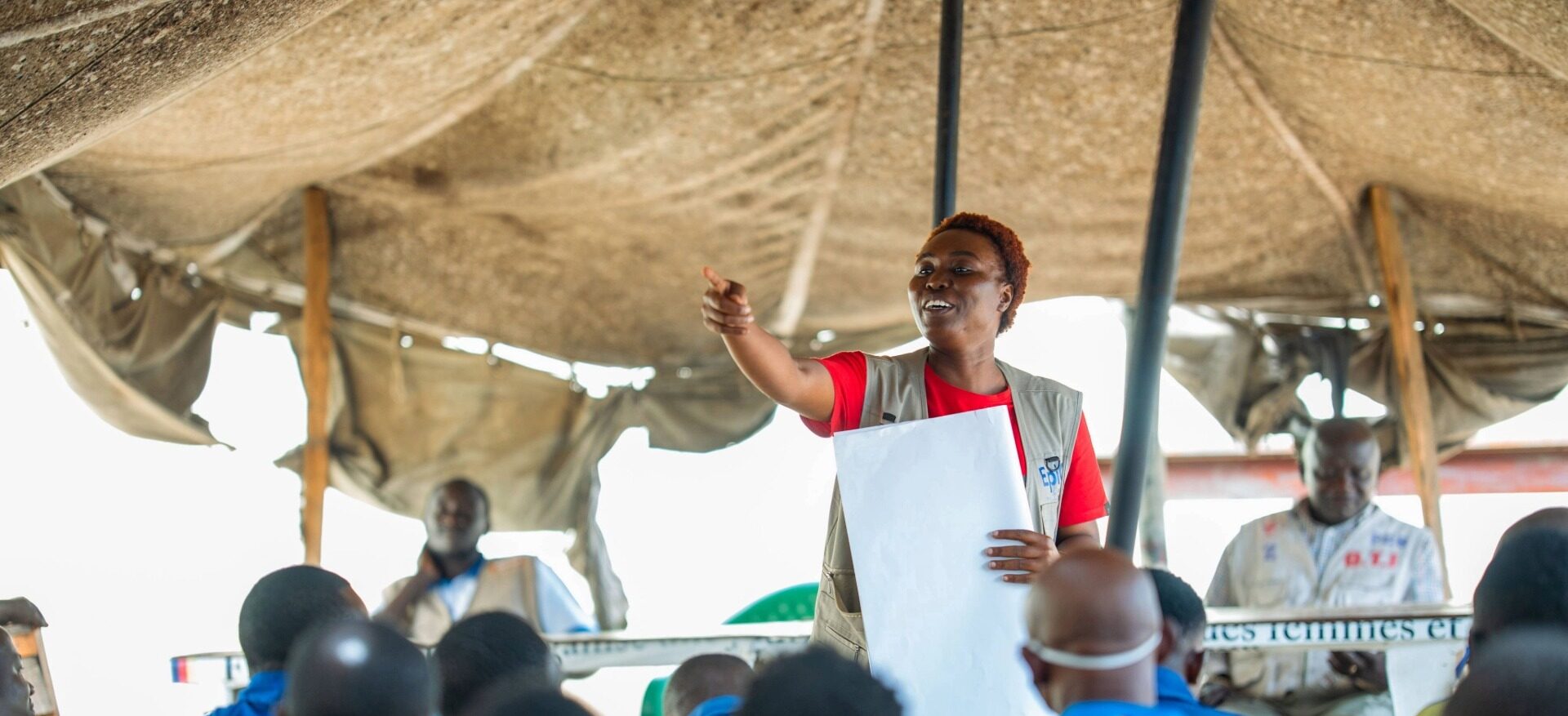 A woman addresses a sitting audience.