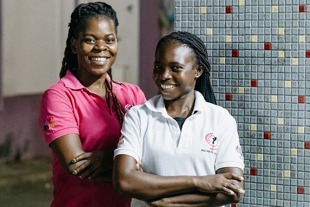 For the Integrated HIV Prevention and Health Services for Key and Priority Populations (PASSOS) project, FHI 360 used a peer outreach model in an effort to reduce the spread of HIV among key and priority populations in Mozambique. Peer educators like Silvia (left) and Serafina (right), pictured here at an HIV testing site in downtown Maputo, provided information to sex workers about HIV prevention, testing and treatment, as well as violence prevention and support services. The PASSOS project, now called the