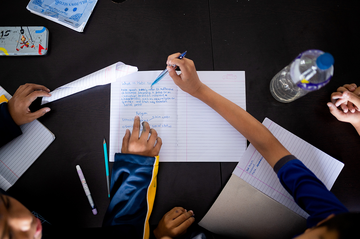 A young student takes notes on hate speech.