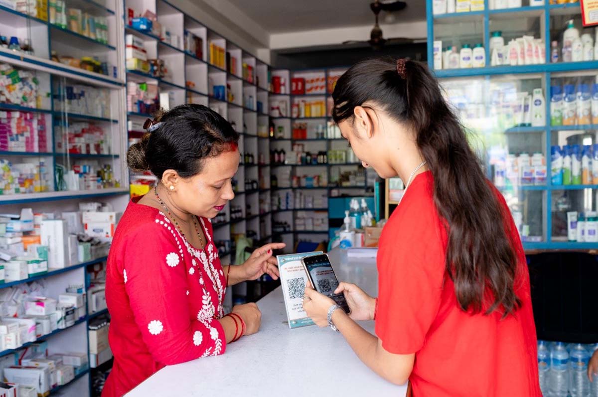 Singh directs a customer to the pharmacy’s QR code, through which they can leave anonymous feedback about the services they received.